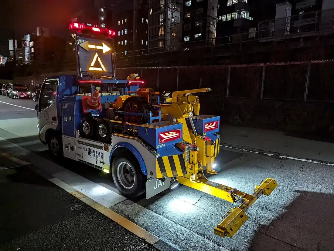 Tow truck equipment illuminated at night